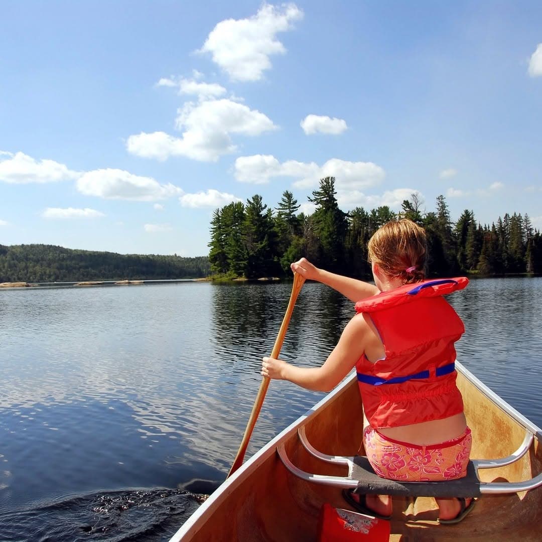 Child paddling a canoe on Georgian Bay near Honey Harbour
